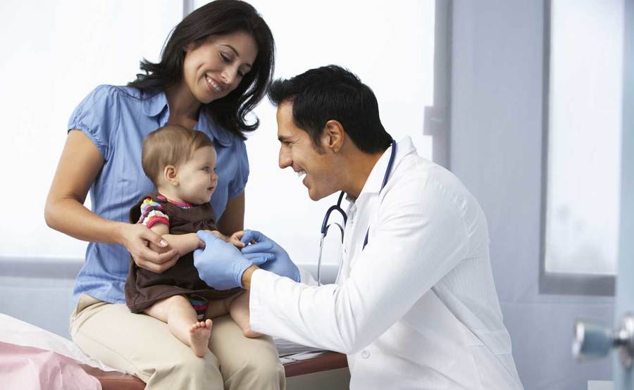A baby gets checked by a doctor, representing the compassionate medical attention you can expect at Scripps urgent care in San Diego.