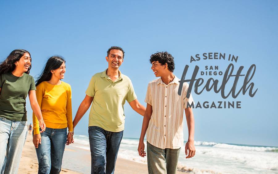Abhi Adappa and his family laugh on the beach after Abhi, 46, recovering from surgery following a severe neck injury.
