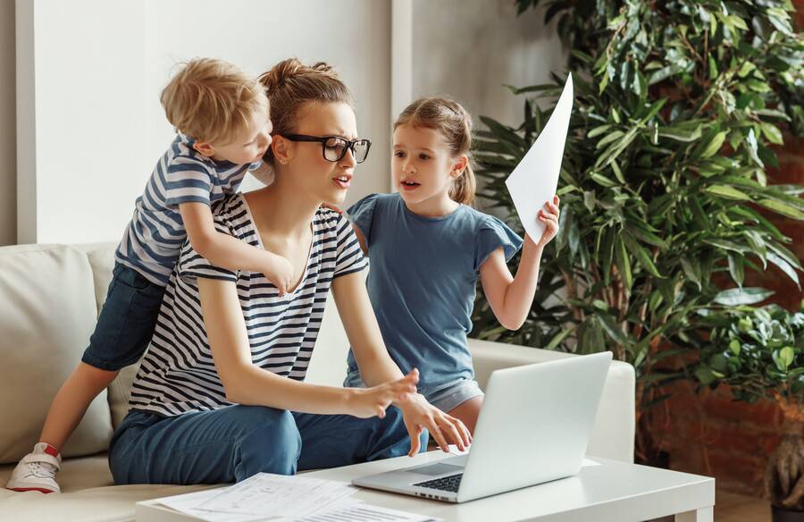Busy mom trying to work and take care of her kids.