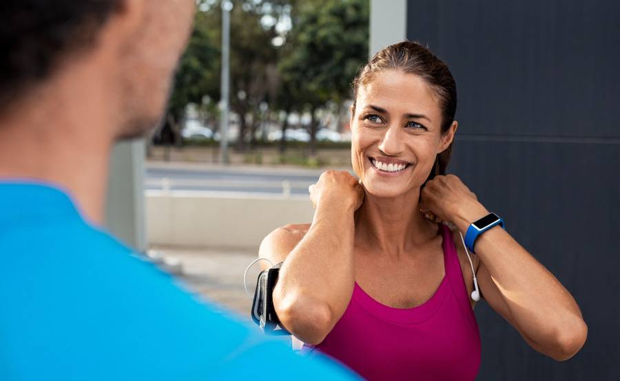 A middle-aged woman wearing a fitness tracker and workout clothes represents people treated for cardiomyopathy at Scripps.