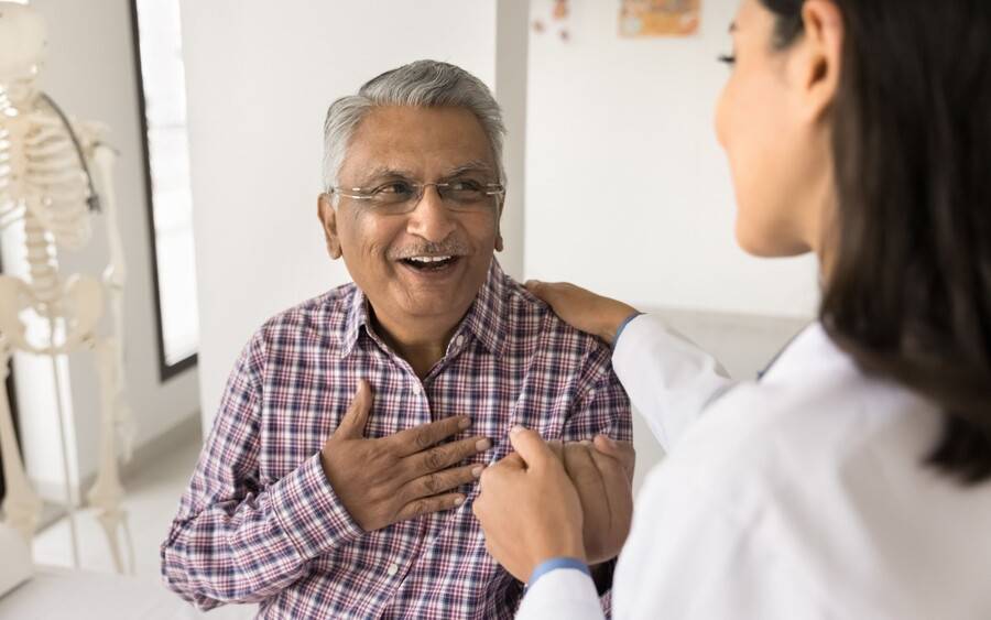 A cancer patient discusses side effects of chemotherapy with his health care provider.
