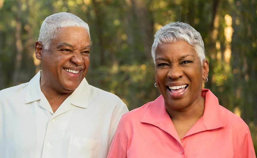 A smiling middle-aged African-American man and woman represent the full life that can be led after digestive cancer treatment.