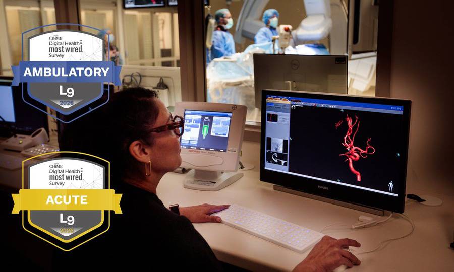 CHIME Digital Health most wired awards for ambulatory and acute logos for 2026 displayed on an image showing a healthcare worker working on a computer looking into a surgery room.
