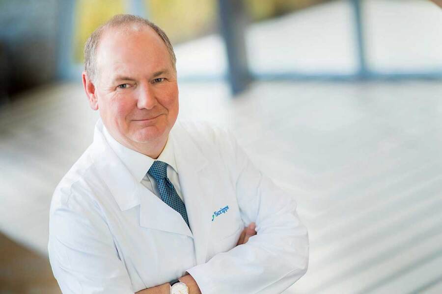 Dr. Buchholz with his arms crossed smiling ay the camera.