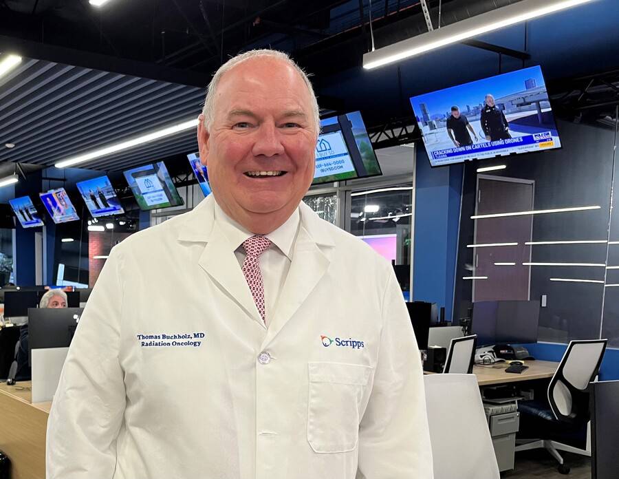 Dr. Thomas Buchholz, Scripps Cancer Center and Scripps Clinic standing on a news room.