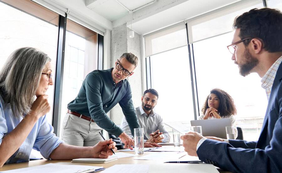 A group of professionals meeting in a board room setting.