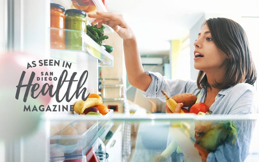 A woman pulling fruits and vegetables from her refrigerator is getting ready to make a healthy meal that fits her nutrition and weight management goals.