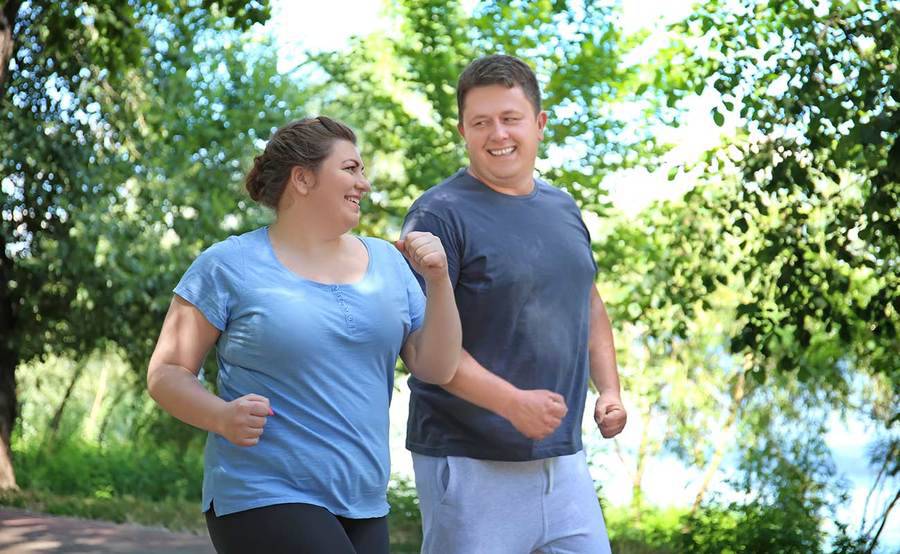 A couple walking outdoors for exercise, representing the active lifestyle people often enjoy after gastric banding surgery.