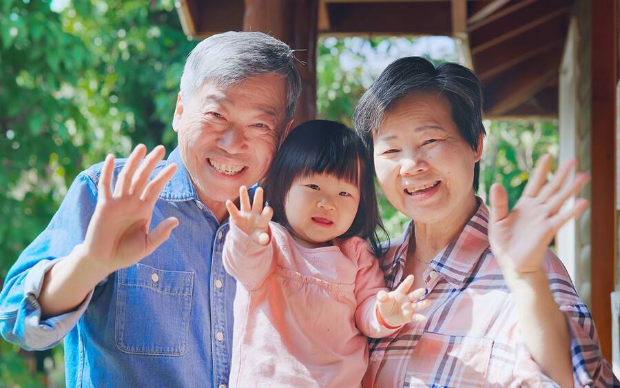 A pair of grandparents bond with their young grandchild.
