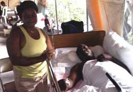 Haiti patient and relative being cared for by Scripps volunteers. 