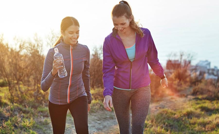 Two women enjoy an outdoor hike, representing the range of birth control and family planning options available at Scripps.