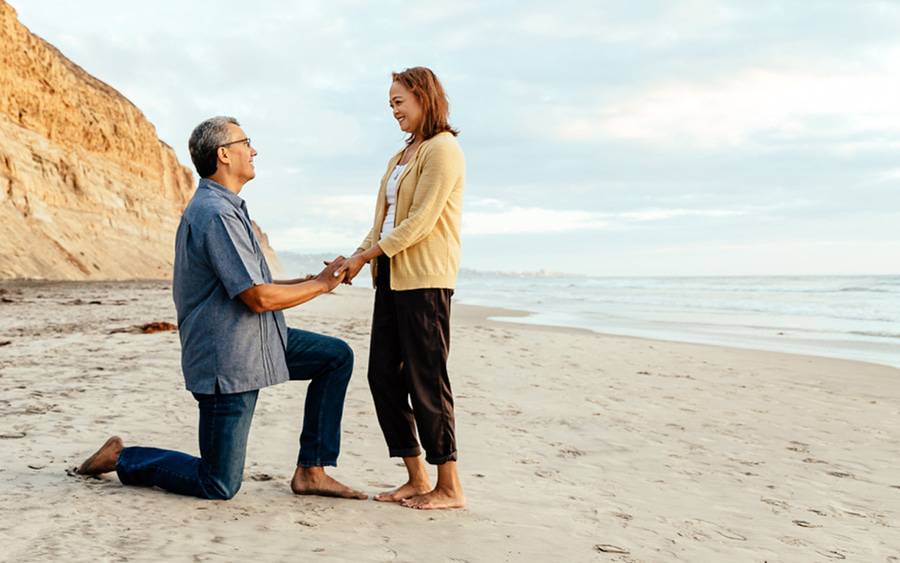 A husband and wife share a romantic on the beach after he successfully donated his kidney to save her life.