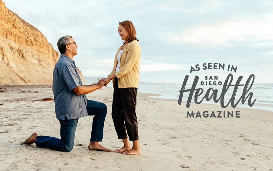 A man and his wife hold hands on a beach while celebrating five years of good health after a living donor kidney transplant at Scripps Center for Organ and Cell Transplantation.