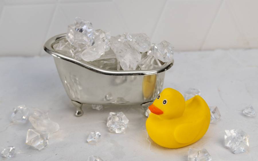 Illustration for ice baths features small tub filled with ice cubes and a rubber duckie.