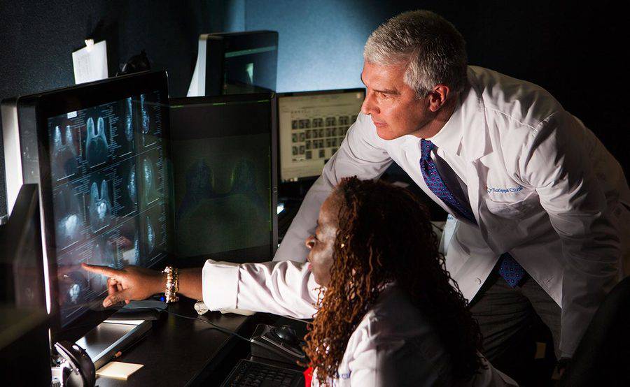 Two Scripps Clinic radiologists review imaging results on a computer monitor, representing our combination of expertise and state-of-the-art equipment.