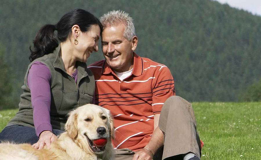 A smiling middle-aged couple represents the full life that can be led after intestinal cancer treatment.