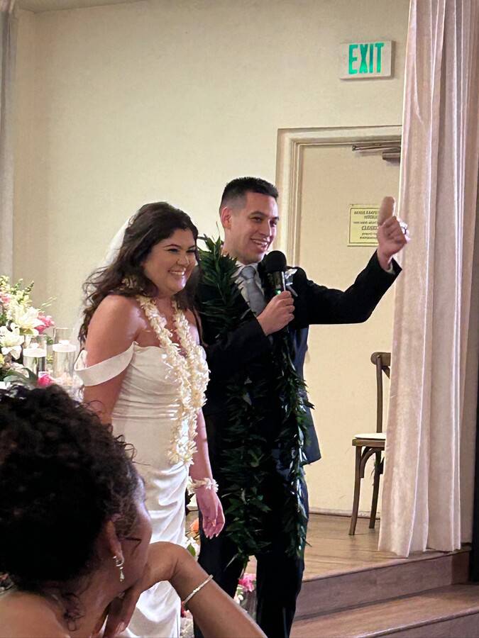 Jordan Mendoza gives the thumbs up after their vows on their wedding day.