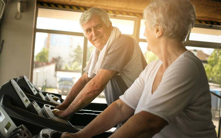 Mature couple working out on treadmmills to keep their weight in check and help relieve osteoarthritis symptoms.