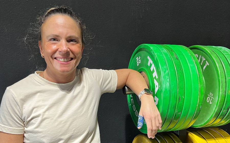 Natasha Henderson standing next to weights after she's recovered from her injury.