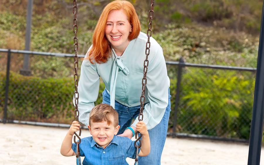 Olivia Smoak pictured with her son on the swing at the playground. Advanced life support saved her from a rare birth complication.