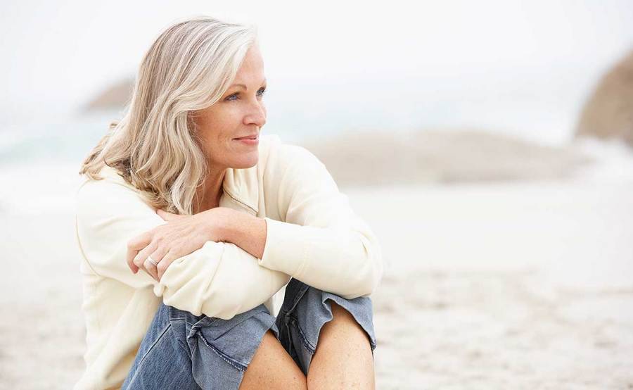 A smiling mature woman represents the full life that can be led after ovarian cancer treatment.