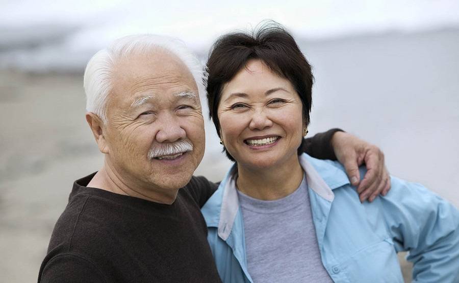 A smiling mature Asian couple represents the full life that can be led after pancreatic neuroendocrine tumor treatment.