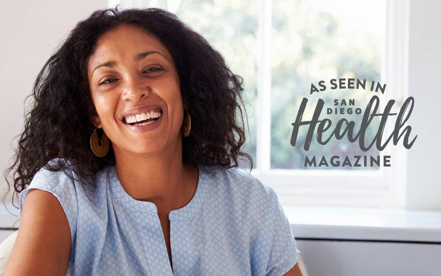 A woman in her 40s smiles as she enters perimenopause. San Diego Health Magazine