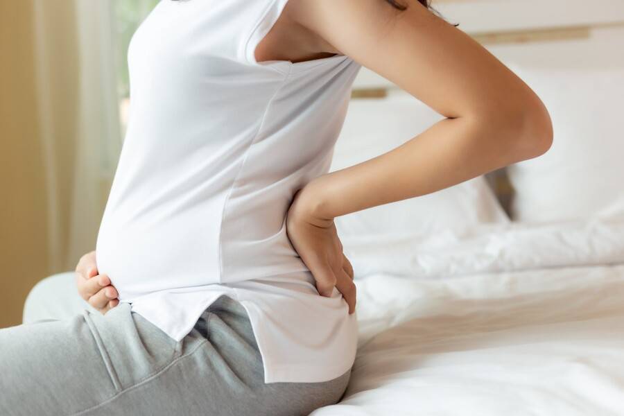 A pregnant woman experiences discomfort.