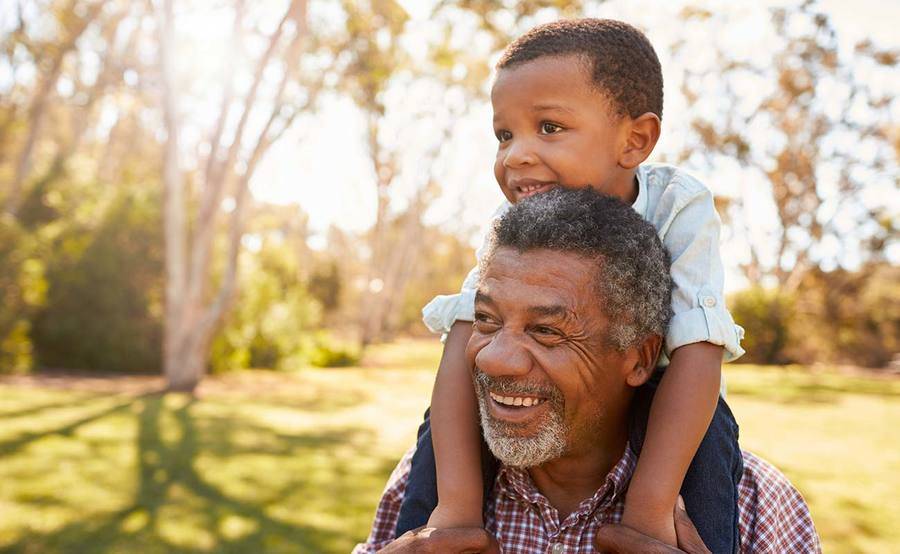 A mature African-American man with grandson represents the power and value of knowing prostate cancer symptoms.﻿