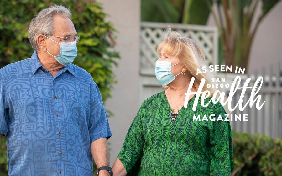 Cherie and Larry Eyer hold hands as they walk in front of their home while being monitored by Scripps during their COVID recovery.