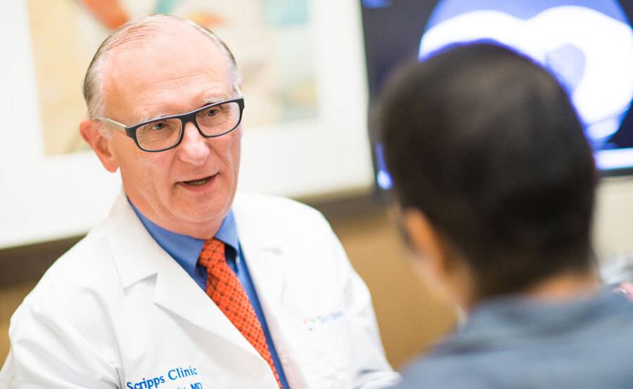 Oncologist and lung cancer expert Michael Kosty, MD, talks with a patient at Scripps in San Diego.