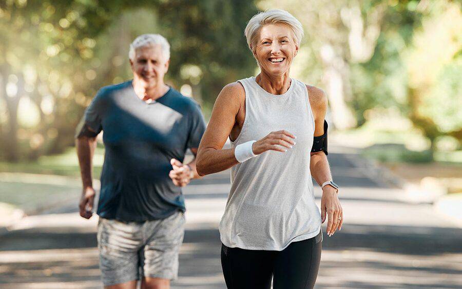 A mature couple jogs in a park, representing how Scripps cardiologists achieved a leaky tricuspid heart valve first.