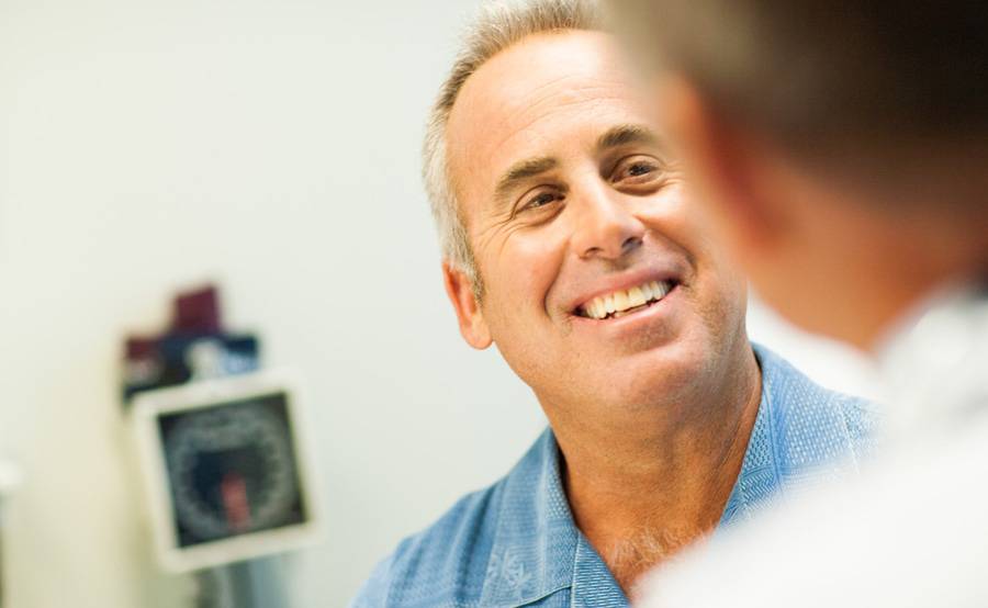 A middle-aged man meets with a nurse practitioner at a Scripps walk-in clinic, which offers care for minor illnesses and injuries.﻿