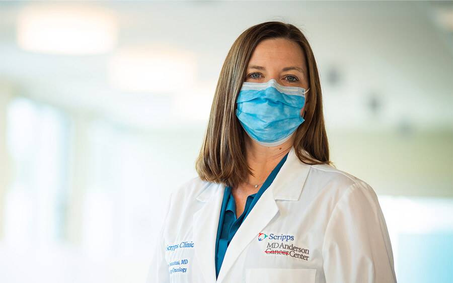 Carrie Costantini, MD, wears a mask and white coat, and shares key advances in breast cancer treatment.