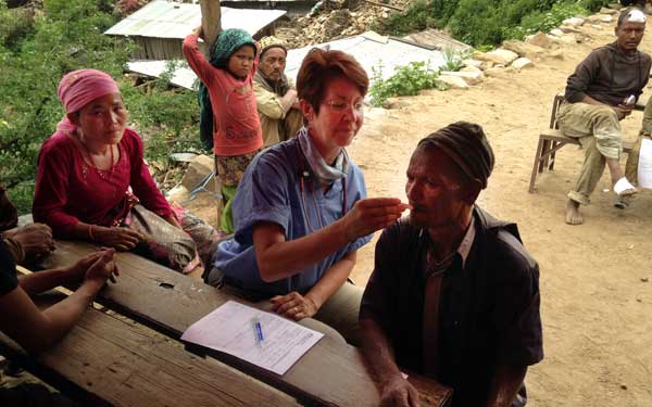 Scripps Health Medical Response Team member Debra McQuillen examines patients at a temporary medical clinic set up in a remote Nepal village damaged by the recent earthquakes. (Photo credit: Scripps Health)
View high-resolution image
