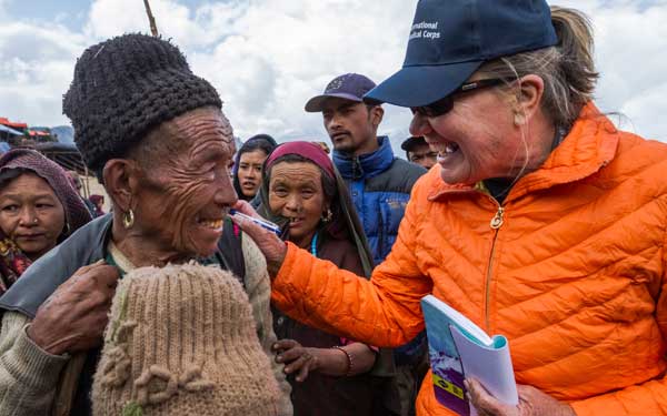 Scripps Health Medical Response Team member Jan Zachry, RN, greets a man after arriving by helicopter in a remote mountainous village damaged by the recent earthquakes in Nepal. (Photo credit: International Medical Corps).
View high-resolution image