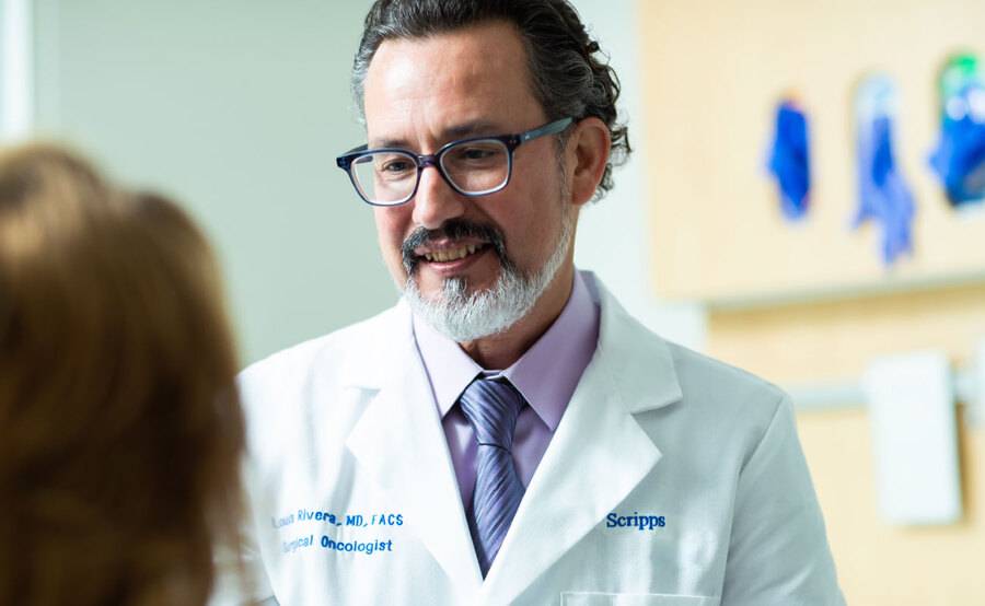 A male doctor helps a patient via philanthropic support for Scripps Mercy Hospital.