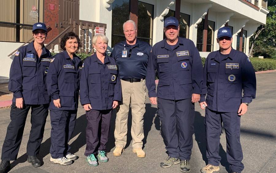 Scripps CEO, Chris Van Gorder (center) with Scripps medical response team members as they prepare to leave for the Camp Fire.