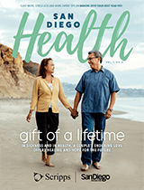 The cover of the December issue of San Diego Health magazine shows a San Diego couple walking on the beach.