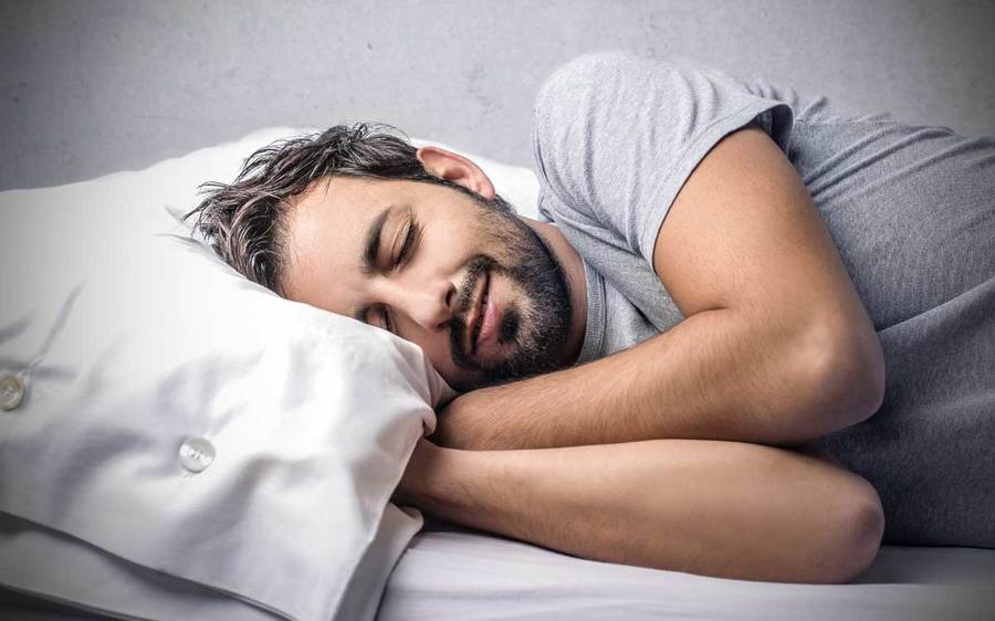 A man diagnosed with sleep apnea attempts to get a good night’s sleep.