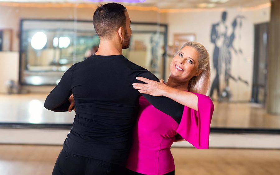 San Diego resident Suanne Summers practices ballroom dancing with a partner after spine surgery at Scripps.