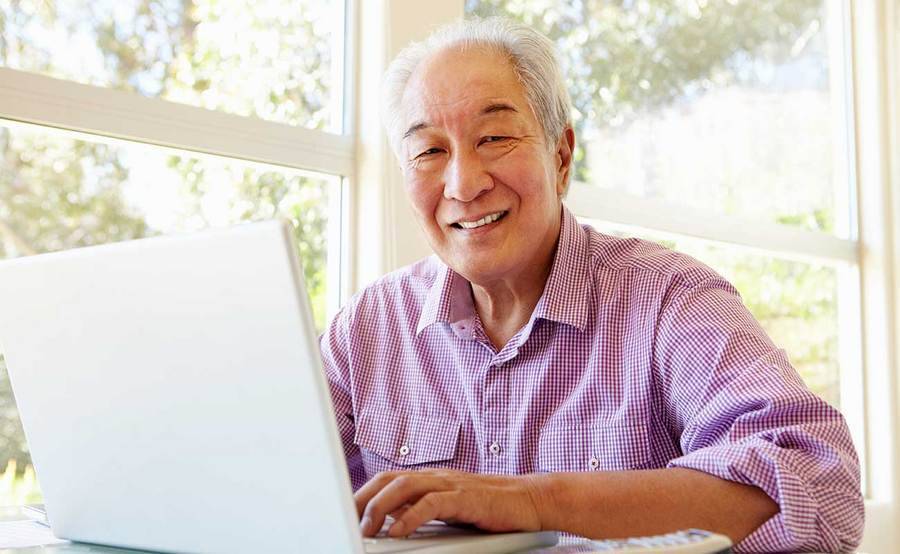 A smiling mature Asian man represents the full life that can be led after stomach cancer treatment.