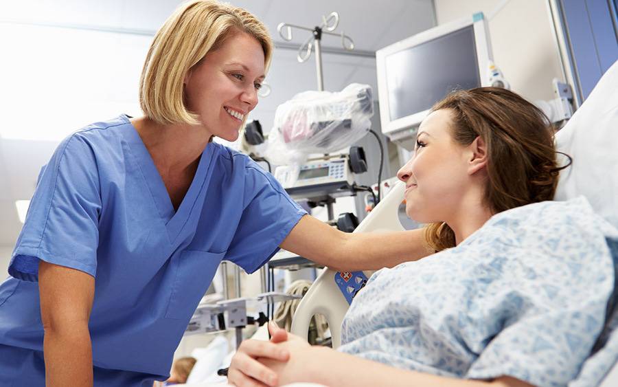 A provider with a patient in a hospital setting.
