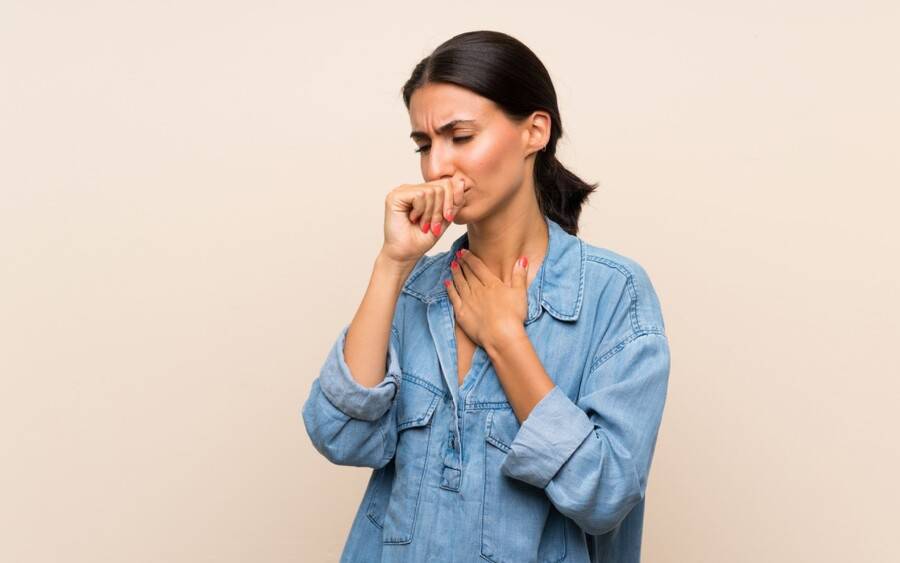 A woman at risk for TB is shown coughing, a sign of potential tuberculosis. Only way to know for certain is to be tested.