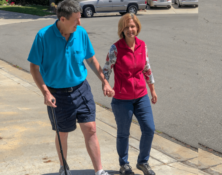 Chula Vista man walks with aid of a cane and his wife after undergoing surgery to remove bone tumor.