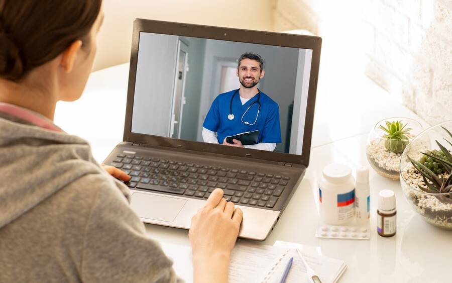 Doctor conducts medical appointment using video conferencing.