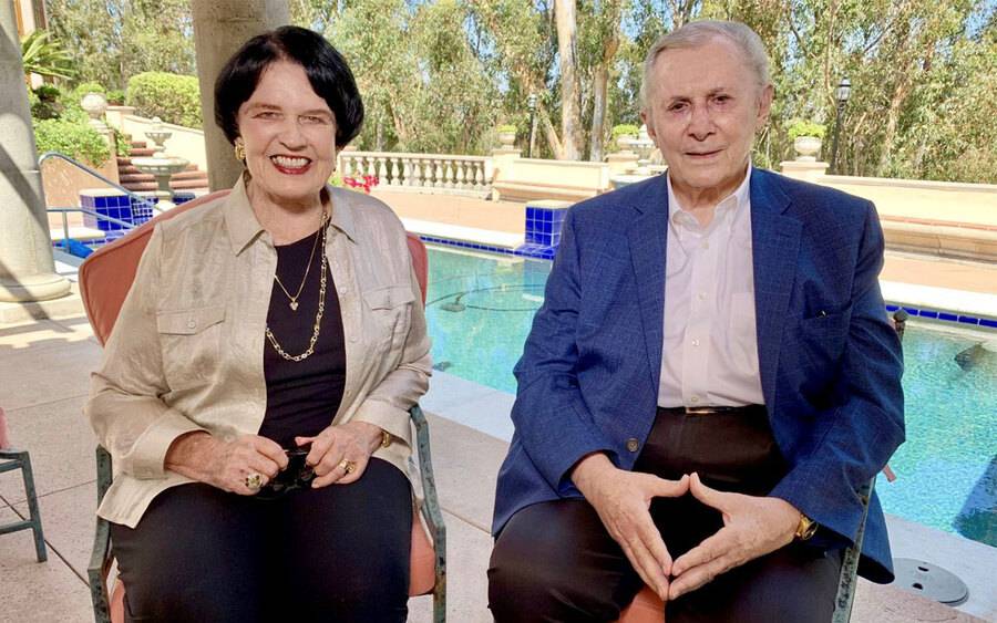 (From left) Debbie and Warner Lusardi sit near a sparkling pool and are happy about their recent $25 million gift to Scripps.