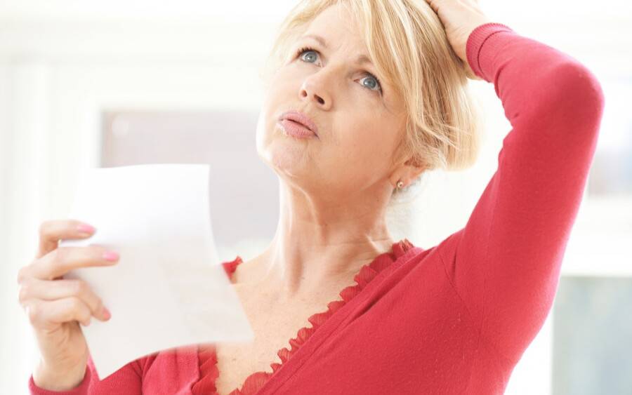 An older woman experiencing hot flashes, menopause symptoms.