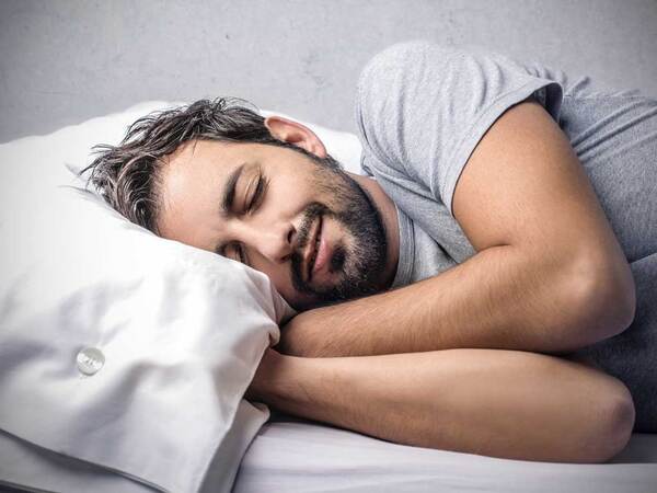 A man diagnosed with sleep apnea attempts to get a good night's sleep. 