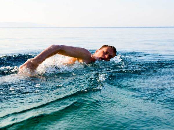 A man swimming in open water.